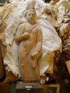 Terracotta Buddha statue from the site of Hadda. The statue was photographed at the moment of unwrapping in the presidential palace, Kabul 2004 - © Fredrik Hiebert, National Geographic Society