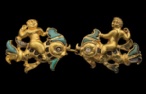 Cat. No. 80: Pair of clasps depicting Cupids on dolphins (Tillya Tepe, Tomb III, 1st century BC -1st century AD, gold, turquoise and mother-of-pearl, dim. of left clasp: 4.2 x 5.2 x 7 cm (1 5/8 x 2 1/16 x 1/4); dim. of right clasp: 4.1 x 5.6 x 7 cm (1 5/8 x 2 3/16 x 1/4) - National Museum of Afghanistan © Thierry Ollivier / Musée Guimet