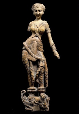 Fig. 13: Cat. No. 148 Statuette of a woman standing on a  makara, possibly a furniture ornament (Begram, Room 10), 1st - 2nd centuries AD (ivory, 45.6 cm (17 15/ 16)) - National Museum of Afghanistan © Thierry Ollivier / Musée Guimet