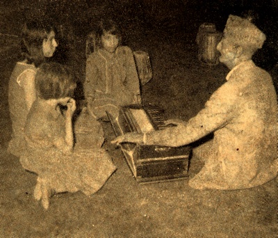 Ustad Ghulam Hussein with children, Kabul, Afghanistan, 1945. Maestro Ghulam Hussein is considered "The Father of Music" in Afghanistan. He is held in high esteem for his progressive thinking about the role of music in culture. The original songbook, printed in 1968, was dedicated to him - National Museum of Afghanistan © Thierry Ollivier / Musée Guimet