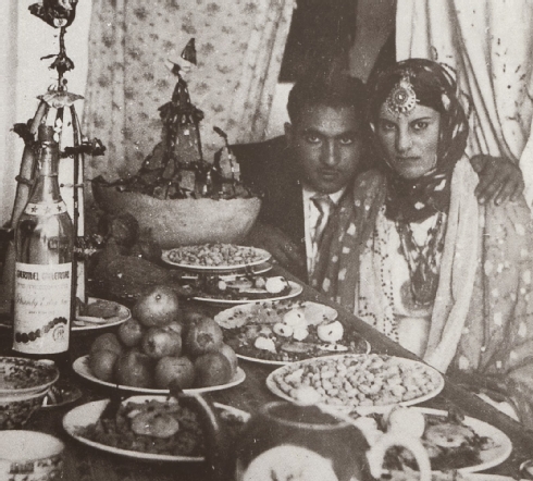 Couple at henna table (note the decorated sugar cone behind the champagne bottle), Herat, 1963 Couple at henna table (note the decorated sugar cone behind the champagne bottle), Herat, 1963